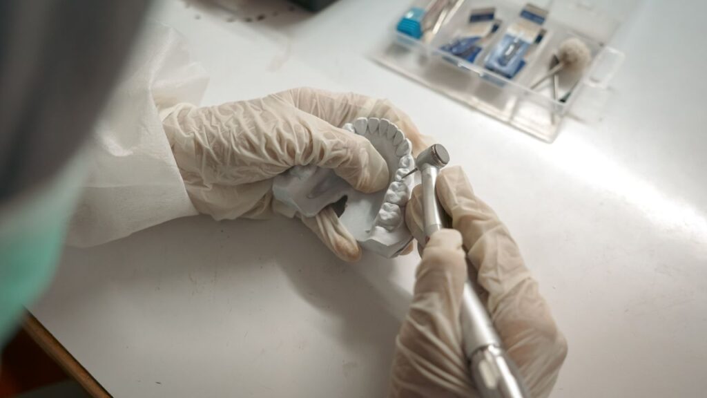 pexels photo 18662954 18662954 Dentist crafting dental prosthetics with precision tools and gloves.